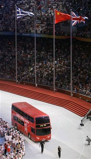 A double-decker bus comes into the National Stadium, signaling the 2012 Olympics in London.